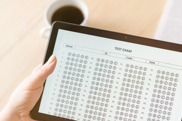 Online exam. Woman student testing exercise. Examination test on the tablet for school, university. multiple choice answer sheet. Home school, online study. Tutorial
