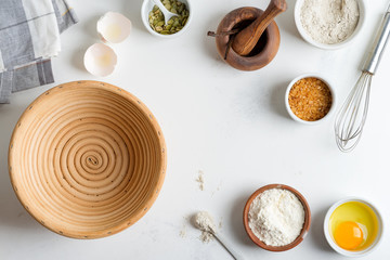 Homemade production of fresh healthy bread of other pastry from natural ingredients on a light grey background.