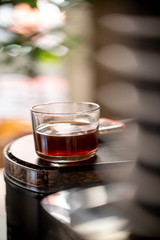 Glass of black filter coffee hario pour over sunlight daylight coffee house cafe