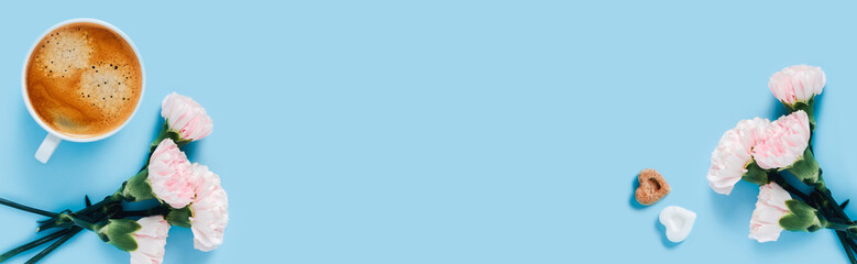 Morning cup of strong coffee with flowers on blue background.