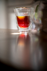 Glass of black filter coffee hario pour over sunlight daylight coffee house leaves cafe