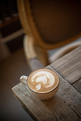 Cup of coffee cappuccino on wooden table texture daylight sunlight cafe coffee house restaurant