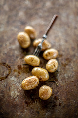 Grilled potato backed on metal pan texture fork daylight sunlight vegetables