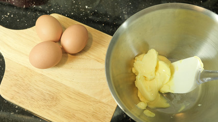 Eggs on wooden board and butter in bowl ,Food concept base of bakery ingredients