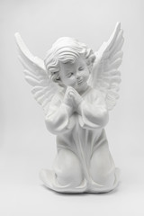 white angel figurine on a white background