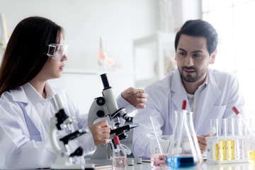 Asia laboratory Two Scientists Conduct Experiments.