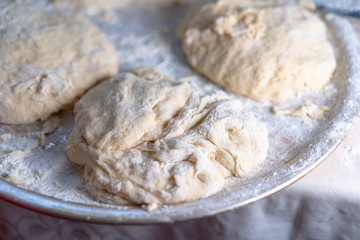 Flour dough sprinkled on a tray