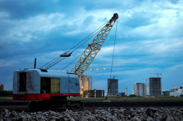 Fototapeta na wymiar Large crawler crane or dragline excavator with a heavy metal wrecking ball on a steel cable. Wrecking balls at construction sites. Dismantling and demolition of buildings and structures