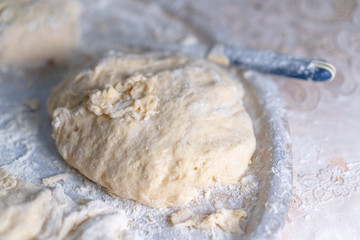 Flour dough sprinkled on a tray