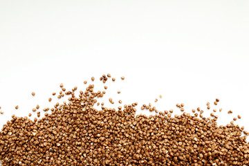 Background, texture-buckwheat on a white background. The concept of healthy, proper nutrition, vegetarianism.