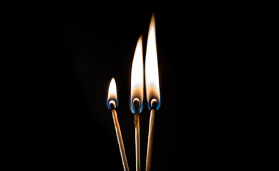 burning matches on a black background