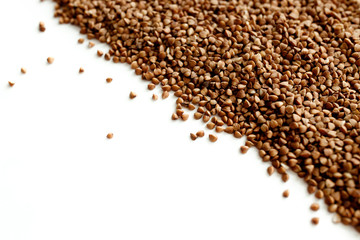Fototapeta premium Background, texture-buckwheat on a white background. The concept of healthy, proper nutrition, vegetarianism.