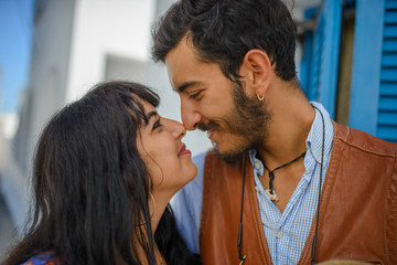A man and a woman are posing in the streets of Imerovigli Village, on Santorini Island..He is an ethnic gypsy. She is an Israeli.