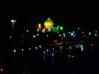 Night view on the lighting streets of Kashan, and mosque on the background, Iran