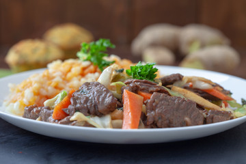 Asian food - roast meat with vegetables and rice