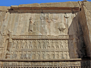 Bas-reliefs above tomb of Persian King Artaxerxes II,  representing himself, Zoroastrian symbol Faravahar, & king's soldiers. Shot in Persepolis, ancient city near Shiraz, Iran