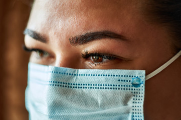 Beautiful Women In A Medical Mask. Close-up of a young girl with a surgical mask on her face...