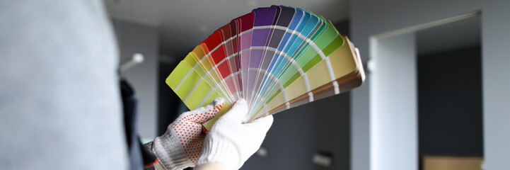 Man holds palette in choosing color for repair