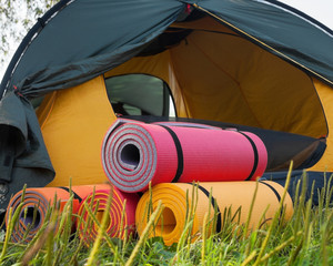Open tent and rolled sleeping pads. © rootstocks