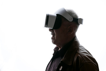Old man using VR helmet on white background. Male in glasses of virtual reality. Augmented reality, game, future technology concept. VR. Free space for text.