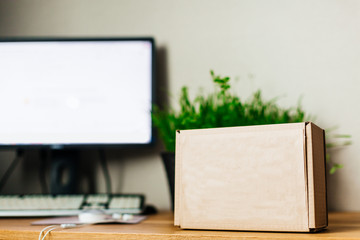 a craft box stands on a table near the computer