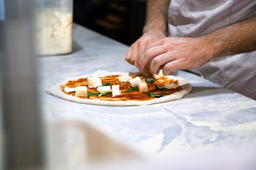 Obraz na płótnie Canvas Chef preparing pizza