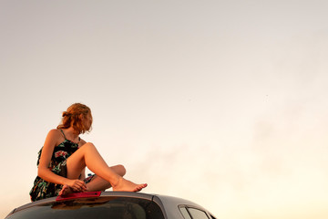 Young woman looking up at the sky. Girl looking towards the horizon.