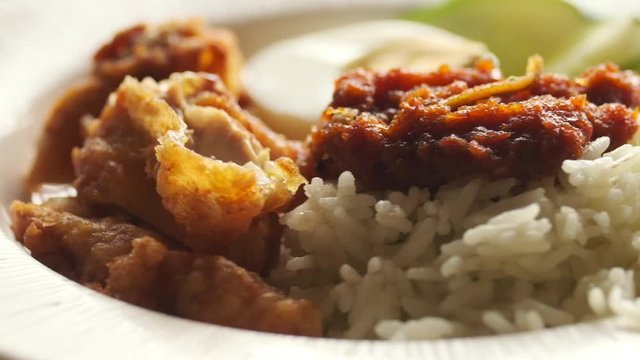 Shallow depth of field footage rotating "nasi lemak" on turntable. Traditional famous Malaysia and Nusantara food.