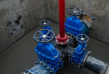 Gate valves in valve pit of the underground piping networks. Laying water system pipeline at...