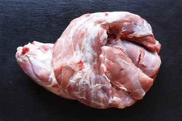 Photography of a lamb shoulder on slate for food background