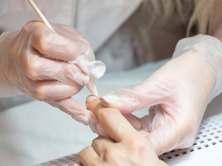 Manicure process. Cleaning the nail from dust, close up