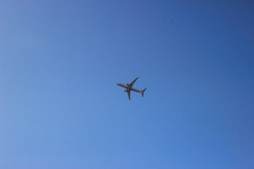 Passenger airplane in clean blue sky. Modern aircraft flying with tourists.