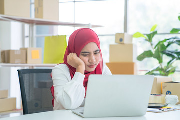 Muslim women sit and work at home, She is tired and stressed with her work, Personal business,...