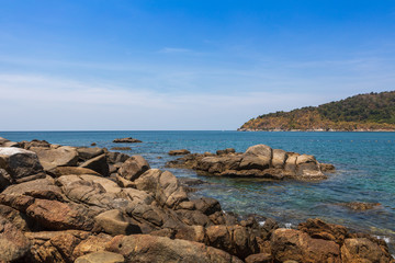 Fototapeta na wymiar view from the rocky shore to the blue water on the island of Phuket Thailand