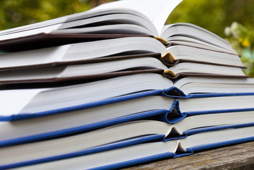 Pile of thick open books