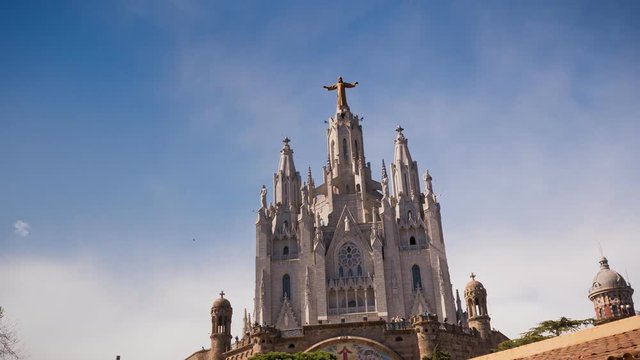Timelapse. Amazing view on old architecture building against the blue sky. The impressive cathedral. Barcelona, Spain.