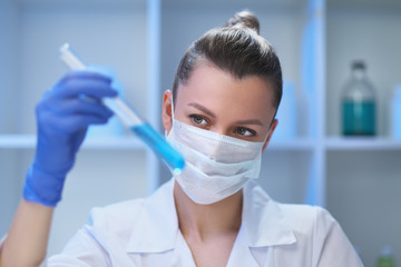 A female medical scientist works in a laboratory. Spcialist conducts experiments, develops auccin auctin from the virus. Coronavirus covid-19.