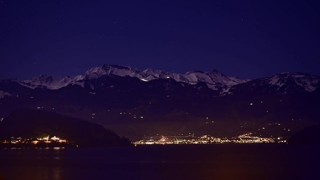 Night view of the Klewenalp mountains and Lake Lucerne. Starry sky. Switzerland.