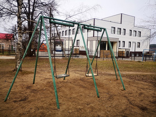 Abandoned playground with two old swings