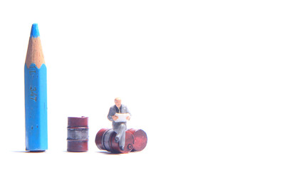 Photo Close Up, Scale HO Business Man Toy, Reading Business Report Beyond Red Barrel and dirty...