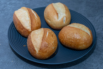 A few freshly baked bread rolls on dark background