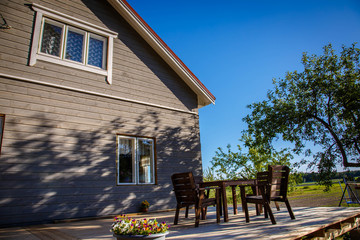 porch of a gray finnish house with a table and chairs