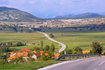 Naklejka premium Autumn Balkan road trip. Bosnia and Herzegovina, Republika Srpska, Zubacko polje. View of Grab village and road to Trebinje city