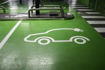 Sign on electric car asphalt