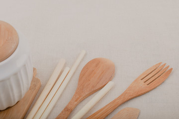 Reusable wooden kitchen utensils, fork, knife, spoon, wheat tubes, textiles. Zero waste concept, environmentally friendly items.