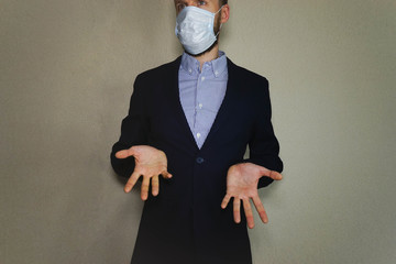 A man dressed as a businessman. He is wearing a jacket, shirt and protective mask. He actively...