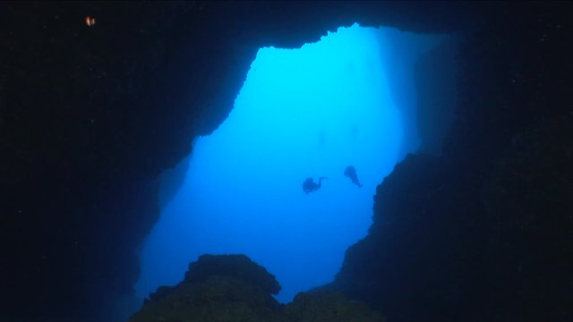 cave diving in deep blue ocean scenery for scuba divers to explore underwater