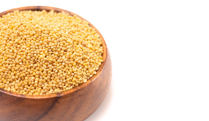 Bowl of Whole Millet in a Wood Bowl Isolated on a White Background