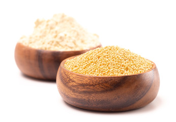 Bowls of Whole Millet and Millet Flour in a Wood Bowl on a White Background