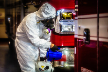 Decontaminating an ambulance in full PPE